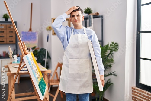 Non binary person at art studio stressed and frustrated with hand on head, surprised and angry face