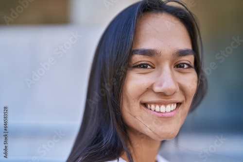 Young beautiful hispanic woman smiling confident standing at street Free Download Young beautiful hispanic woman smiling confident standing at street - GFXLoad