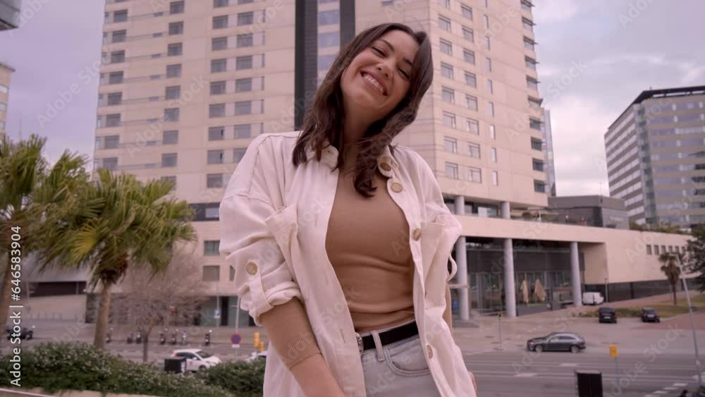Young adult Latina woman excited holding shopping bags outside mall. Beautiful female poses happy and animated outdoor looking and showing off purchases. Generation z lady people addicted to bargains. Young adult Latina woman excited holding shopping bags outside mall. Beautiful female poses happy and animated outdoor looking and showing off purchases. Generation z lady people addicted to bargains.