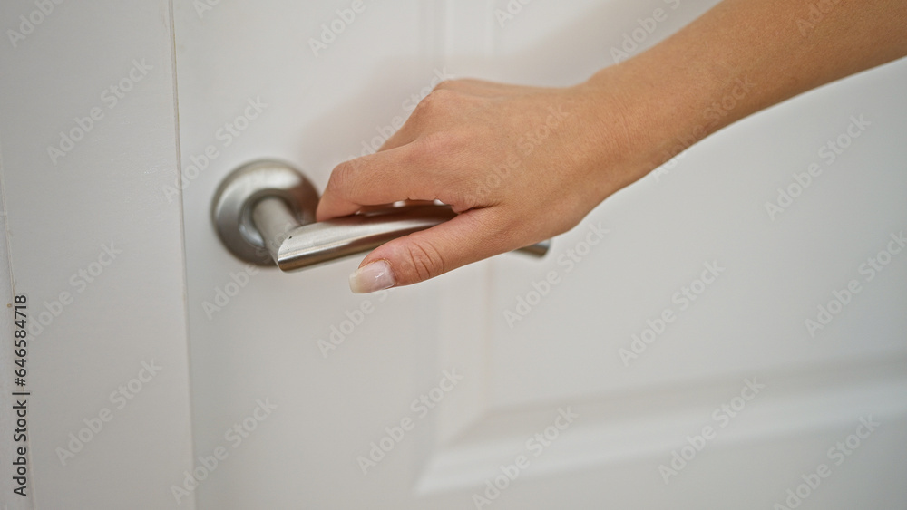 Young woman opening door at home Young woman opening door at home