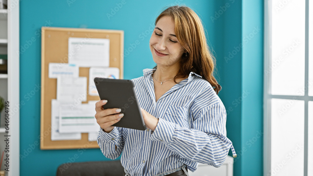 Young woman business worker using touchpad smiling at the office Young woman business worker using touchpad smiling at the office