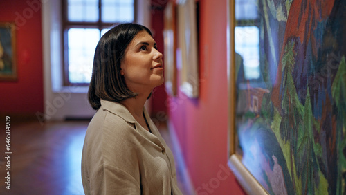 Young beautiful hispanic woman visiting art gallery at Belvedere Palace in Vienna