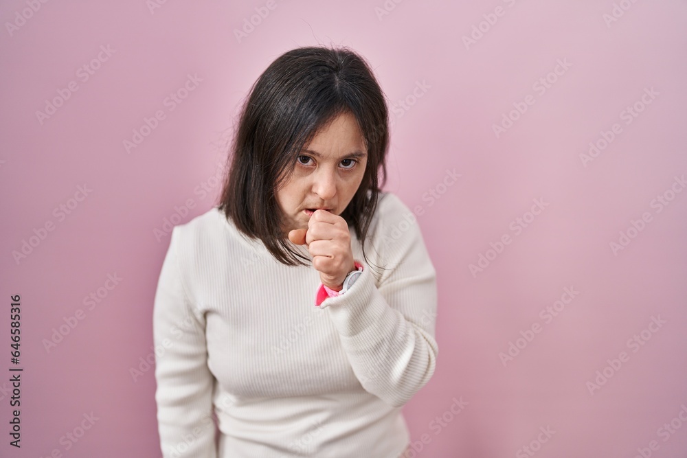 Woman with down syndrome standing over pink background feeling unwell and coughing as symptom for cold or bronchitis. health care concept. Woman with down syndrome standing over pink background feeling unwell and coughing as symptom for cold or bronchitis. health care concept.