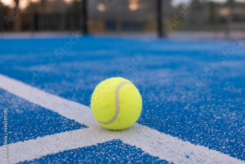 paddle tennis ball on a blue court line , paddle tennis concept © VicVaz