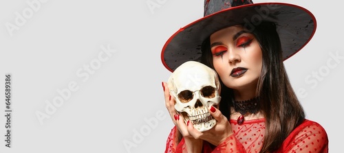 Young witch with skull on l...