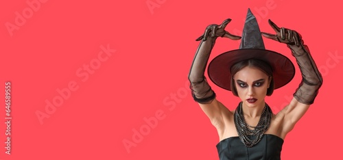 Scary young witch on red ba...