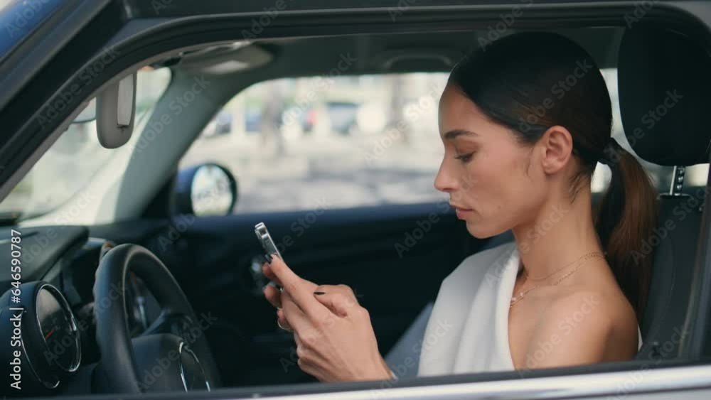 Woman driver looking telephone screen sitting car wheel closeup. Lady with phone Woman driver looking telephone screen sitting car wheel closeup. Lady with phone