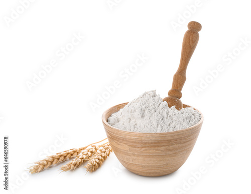 Wheat flour in wooden bowl with scoop isolated on white background