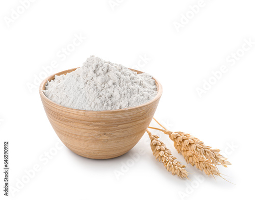 Wheat flour in wooden bowl and spikelets isolated on white background