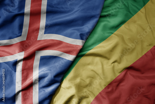 big waving national colorful flag of icelandic and national flag of republic of the congo .