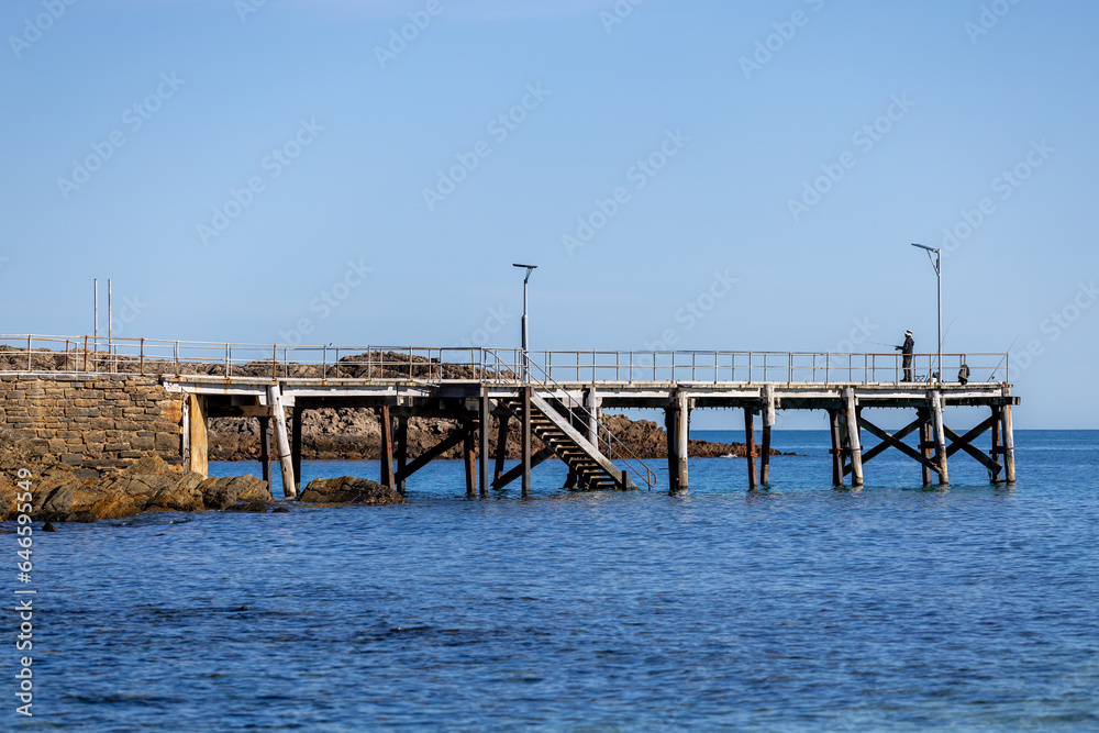 The iconic Second Valley jetty with a man fishing from the end located on the Fleurieu Peninsula South Australia taken on September 11th 2023
