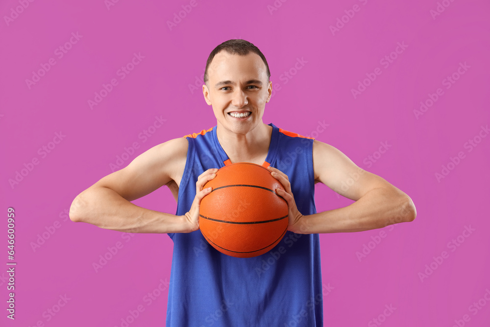 Young basketball player on purple background Young basketball player on purple background