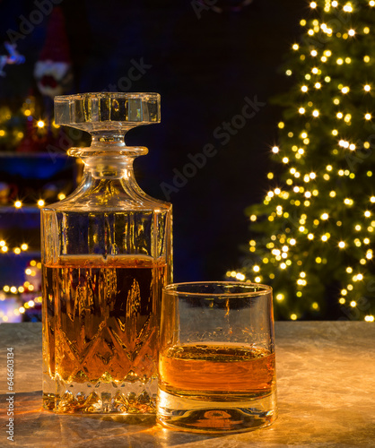 glass of whiskey with christmas lights for background