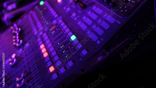 Closeup of sound mixer console music equipment during live band performance concert
