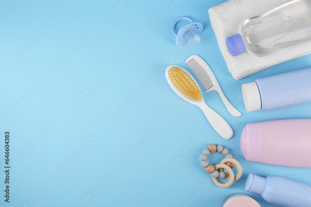 Flat lay composition with baby care products and accessories on light blue background, space for text