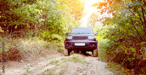 an SUV on a forest road overcomes off-road