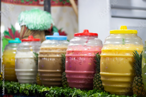 Vitroleros de aguas frescas con sabores de frutas en una paletería de México photo