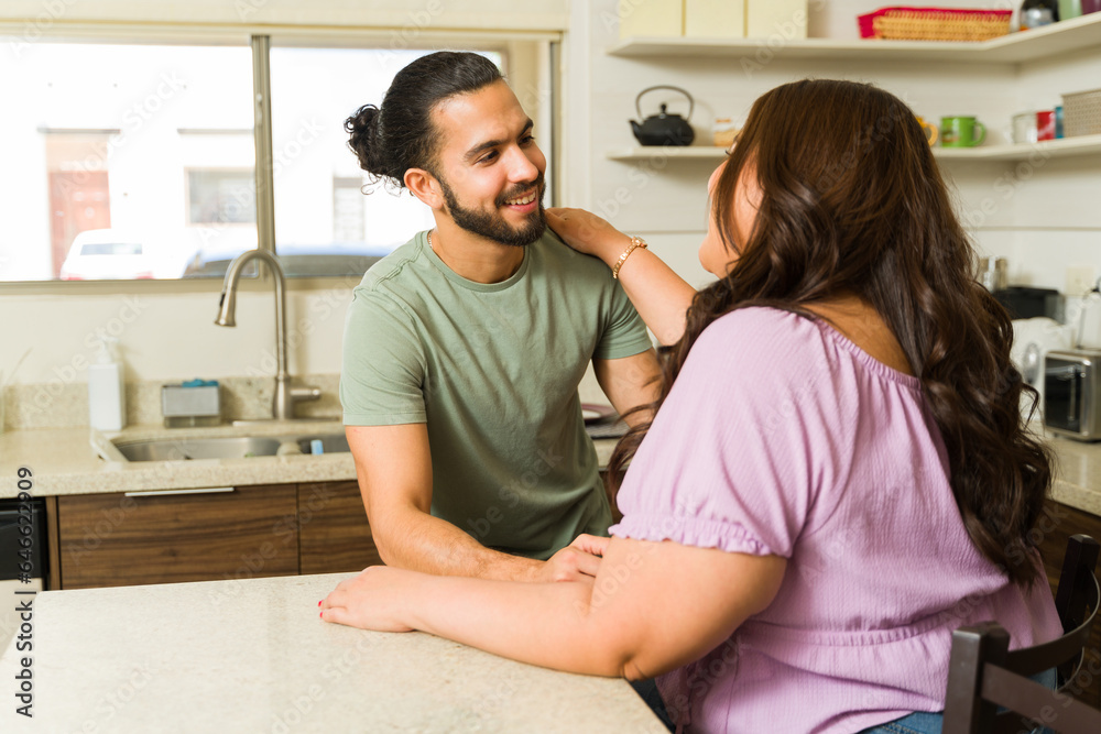 Fototapeta premium Attractive couple in the kitchen after doing house chores