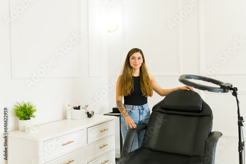 Happy business owner smiling in her beauty room