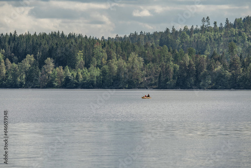 couple Kayaking Boat tour on lake Ragnerudssjoen in Dalsland Sweden beautiful nature forest pinetree