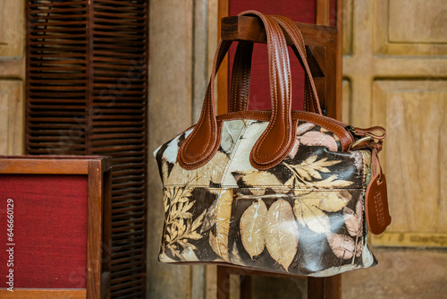 Display of leather bags for women made by craftsmen in Indonesia. Various types of detailed and beautiful women's bags are combined with eco print artwork with leaf and flower motifs