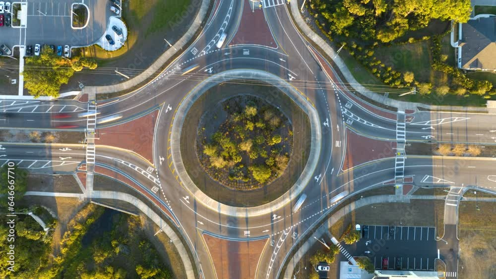 Top view of city street traffic on roundabout intersection with fast moving cars. Timelapse of urban circular transportation crossroads Top view of city street traffic on roundabout intersection with fast moving cars. Timelapse of urban circular transportation crossroads