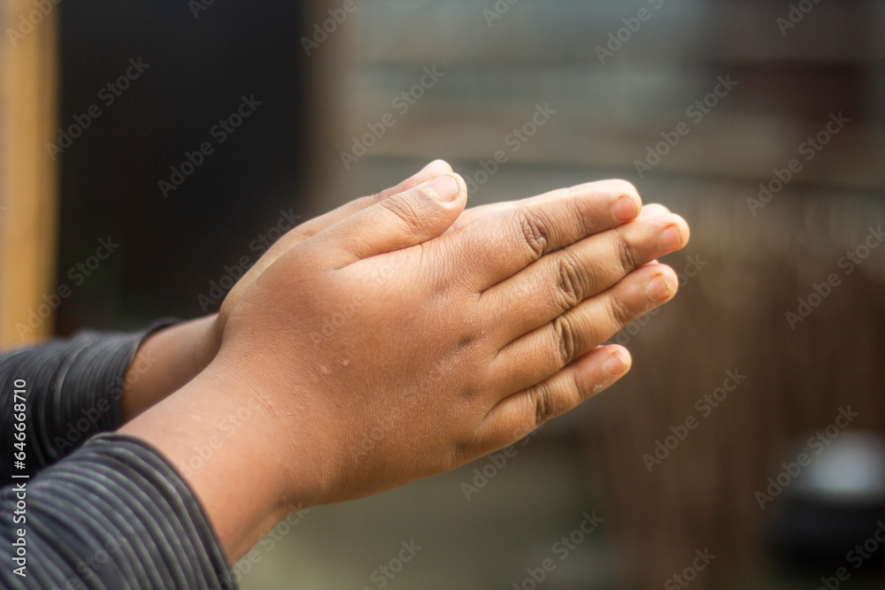 A boy styles his hand and the background blur
