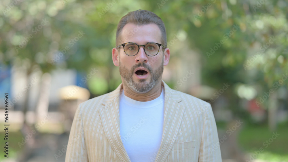 Outdoor Portrait of Shocked Middle Aged Man in Awe Outdoor Portrait of Shocked Middle Aged Man in Awe