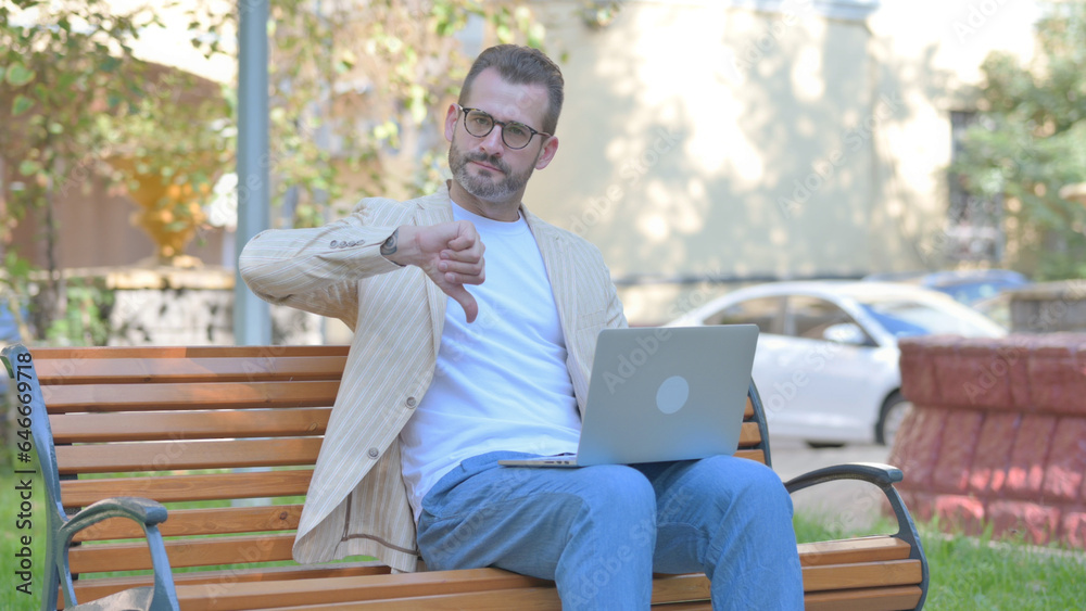 Thumbs Down by Modern Casual Man Working on Laptop Outdoor Thumbs Down by Modern Casual Man Working on Laptop Outdoor
