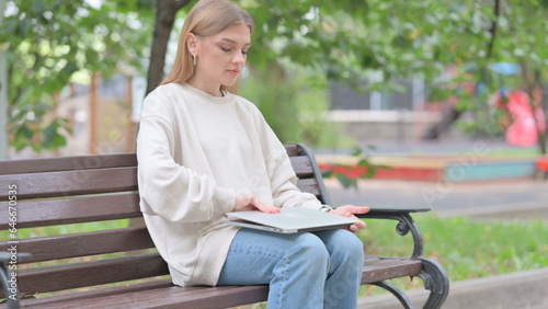Young Woman Coming, Sitting on Bench and Working on Laptop