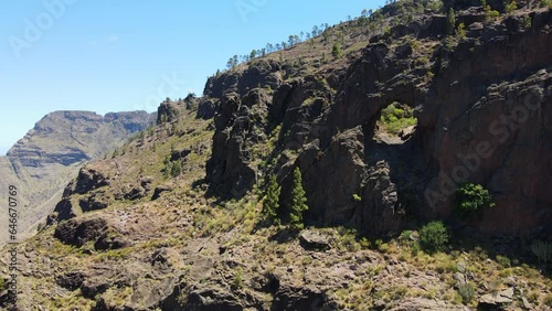Tamadaba natural park, Tirma: aerial view traveling out to rock formations with a hole. Natural park on the island of Gran Canaria on a sunny day. photo
