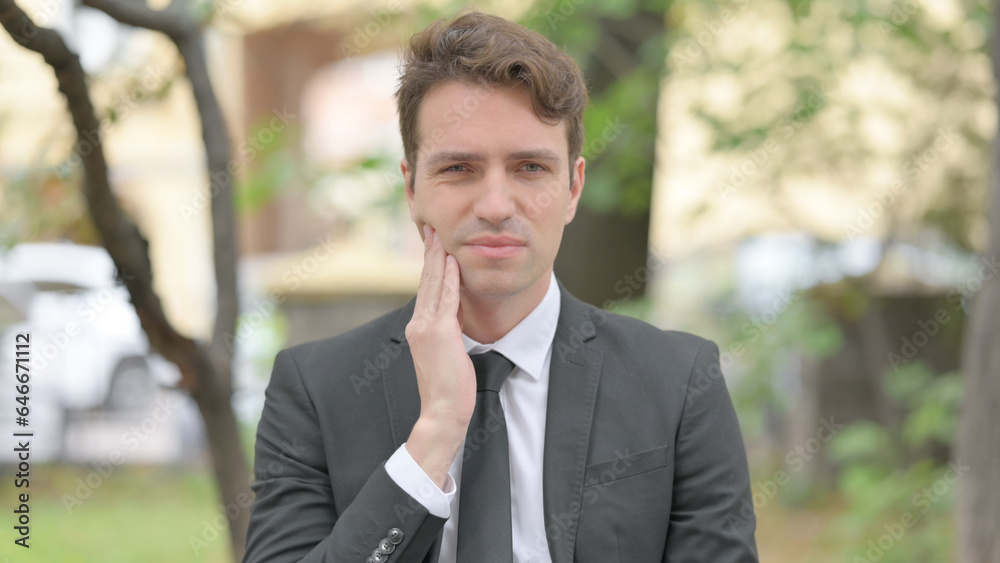 Outdoor Portrait of Businessman with Tooth Infection Outdoor Portrait of Businessman with Tooth Infection