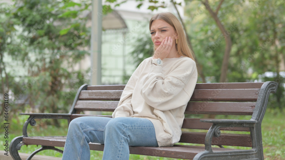 Casual Young Woman with Toothache Sitting Outdoor Casual Young Woman with Toothache Sitting Outdoor