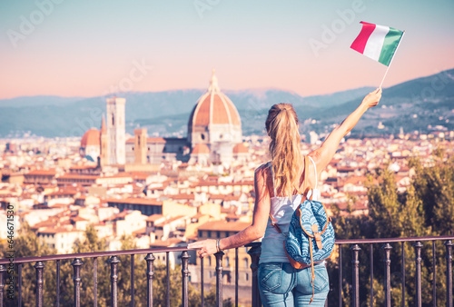 Young woman tourist holding italian flag looking at Florence city- Tour tourism,travel in Italy, Europe