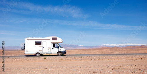 motorhome on the road in desert landscape- road trip, travel, freedom concept