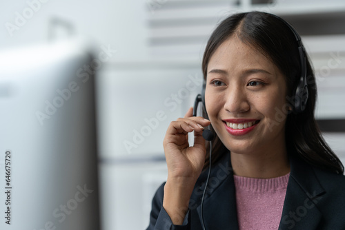 Asia call center with headset and microphone working on laptop Female entrepreneurs serving customers, business information, inquiries Support call center representatives help customers.