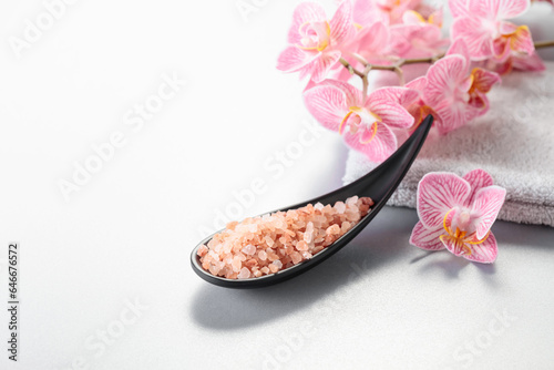 Beautiful blooming orchid flowers and pink sea salt.