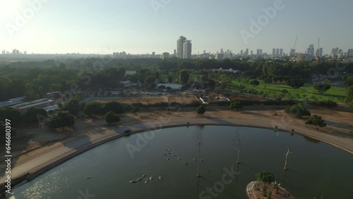 An aerial view in a calm afternoon over the hippopotamus pond of the Ramat Gan Safari when it is empty of visitors. The animals are calm and relaxed in the water - top down shot photo