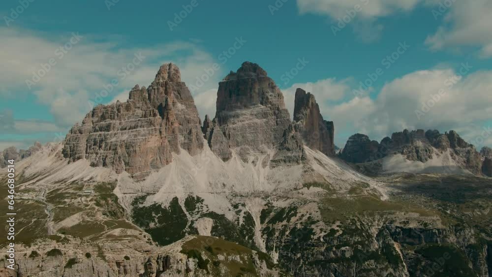 Tracking drone shot with tall steep rocky mountains and partly clouded sky in the background, Vacation and Holiday in the Alps majestic landscape, cinematic color grade Tracking drone shot with tall steep rocky mountains and partly clouded sky in the background, Vacation and Holiday in the Alps majestic landscape, cinematic color grade