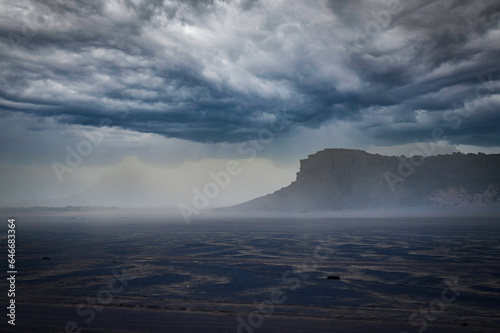 Landscape of desert in the winter with dark clouds and thunderclouds