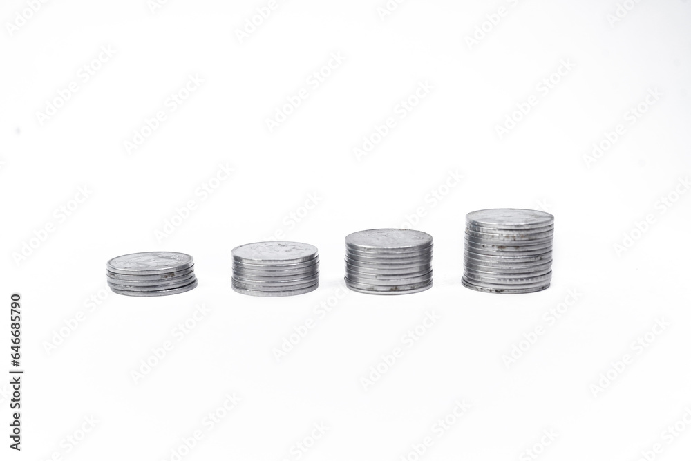 Stack of coins arranged as a graph on white background Stack of coins arranged as a graph on white background