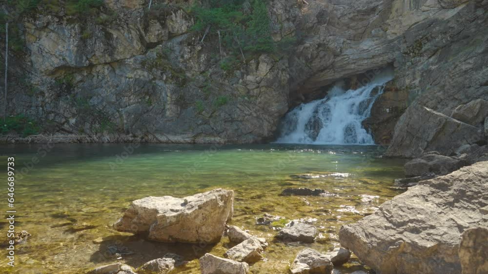 Running Eagle Falls at Glacier National Park, Montana, on a sunny afternoon
