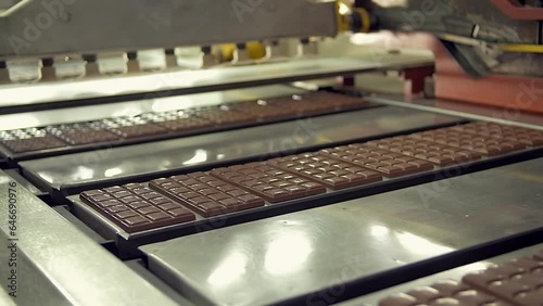 dolly slow motion medium shot of freshly made chocolate bars on the conveyor line