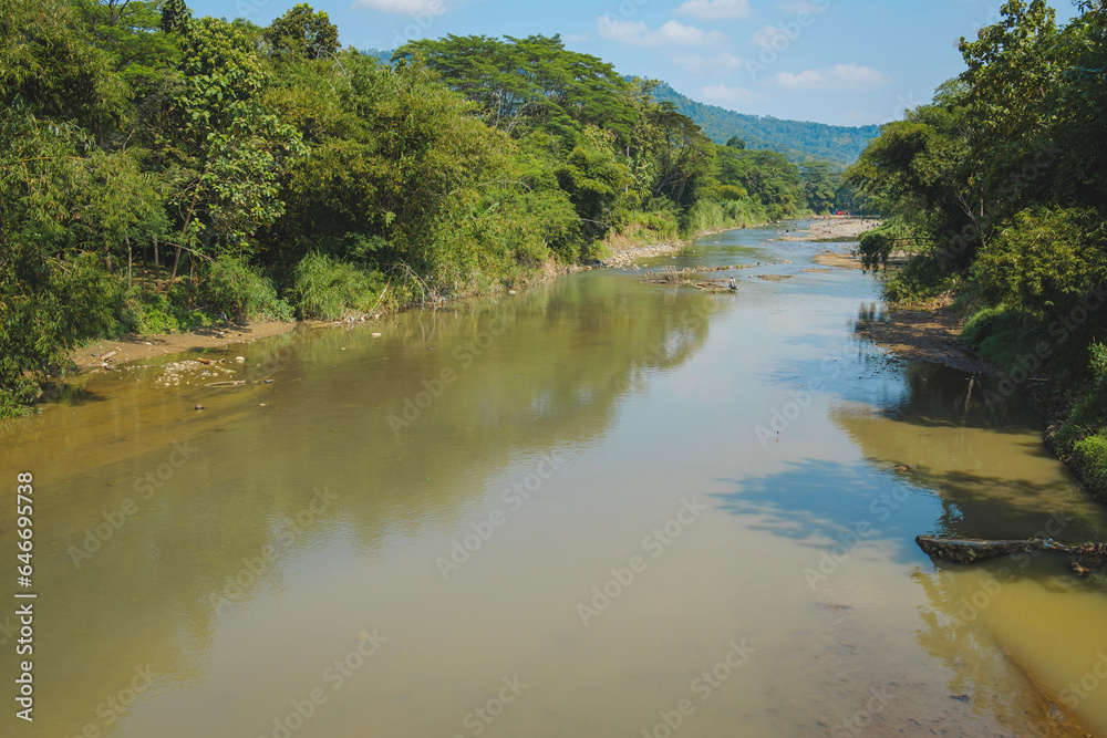 Kuningan west java,calm river accompanied by beautiful trees Kuningan west java,calm river accompanied by beautiful trees