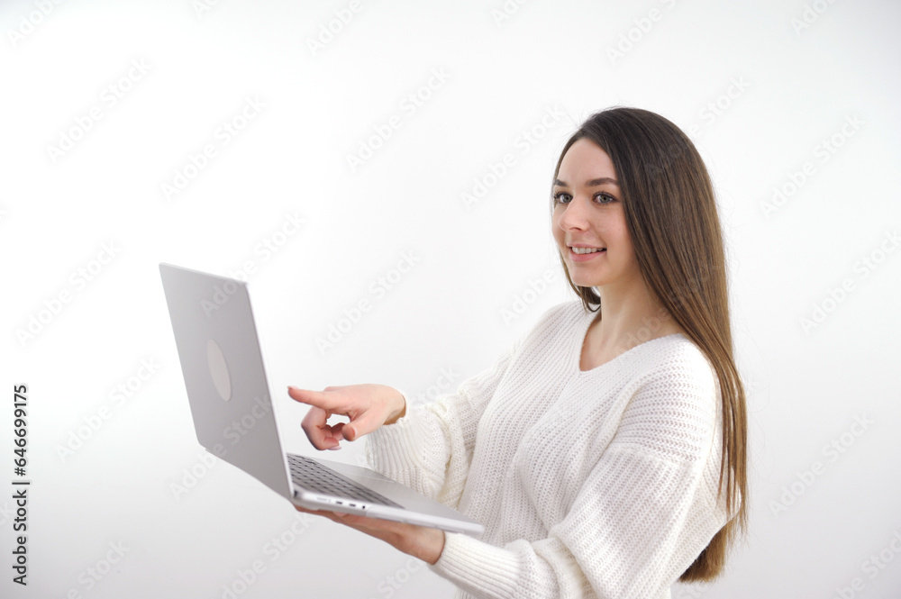 Asian beautiful woman Standing in a white shirt in her hand Holding a laptop computer Stand smiling happily With a white background. High quality photo Asian beautiful woman Standing in a white shirt in her hand Holding a laptop computer Stand smiling happily With a white background. High quality photo
