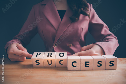 Businesswoman hand flipping wooden blocks cubes text for "PROCESS" to "SUCCESS". Process for success business concept.