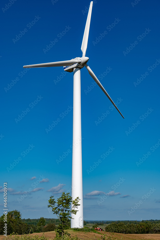 wind turbine standing in field with blue sky wind turbine standing in field with blue sky