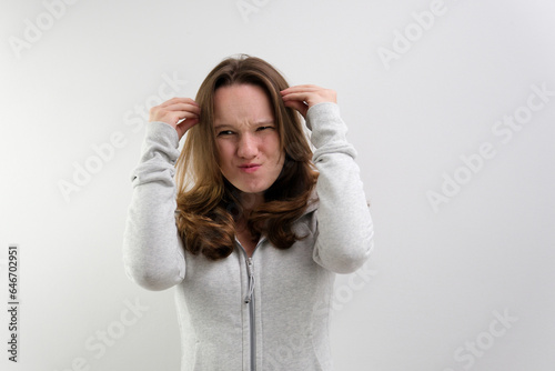 negative emotion of adolescence brain explosion girl with hands shows how it explodes in head experiences opens mouth waves hands boom strong explosion on a white background. emotional teenager