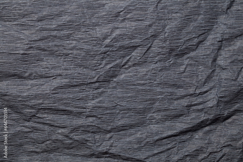 Dark background, crumpled paper, texture. Matte surface. Background, grunge.
