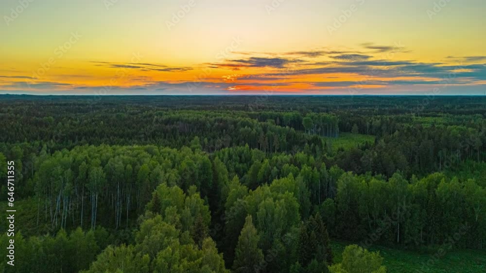 Golden sunset over with a brilliant sky reflecting off a pond - aerial hyper lapse Golden sunset over with a brilliant sky reflecting off a pond - aerial hyper lapse